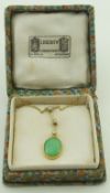 A jade and split pearl pendant, on a chain, pendant 3.