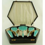 A cased five piece silver and enamel dressing table set, Birmingham 1935,