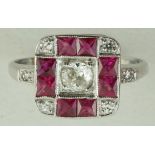 A diamond and calibre ruby panel ring, the white mount stamped '18ct',