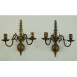 A pair of 17th century style brass wall lights each with two candle arms,