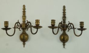 A pair of 17th century style brass wall lights each with two candle arms,