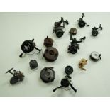 A collection of various modern and vintage fishing reels including various brass and wooden