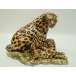 An Italian porcelain figure of a leopard and her cubs on an asymmetrical base, printed marks, 27.