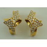 A pair of contemporary design diamond and gold clip earrings, stamped '750' and numbered,