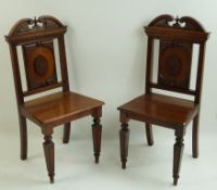 A pair of late Victorian mahogany hall chairs,