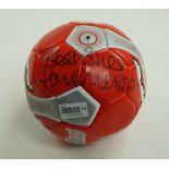 A red Sondico football,