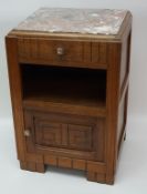 A French Art Deco bedside cupboard with an inset marble top, above one drawer,