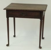 A 19th century oak side table with carved frieze drawers on turned tapering legs with pad feet,