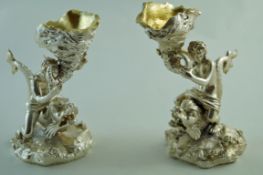 A pair of plated figural, dolphin and shell table salts, after the antique,