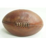 A leather rugby ball by Mark Cross Company,