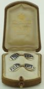 A pair of French gold and enamel cufflinks, the circular panels with a Greek Key style decoration,