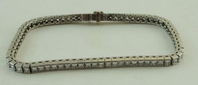 A diamond tennis bracelet, the seventy one Princess cuts totalling approximately 6.