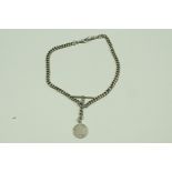 A silver double watch chain, of solid uniform curb links, with two swivels and a T bar,