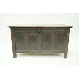 A 17th century oak coffer with quadrupled carved and panelled front, 64cm high, 118cm wide, 52.