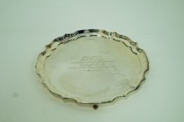 A silver salver, Birmingham 1962, with a Chippendale moulded border, on four scroll supports,