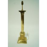 A brass table lamp in the form of a Corinthian column, on flared base,
