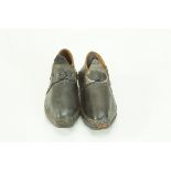 A pair of miniature Lancashire christening clogs, with wooden soles and iron nailed rims,