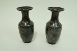 A pair of Japanese style spelter vases with engraved a gilded birds and plants on a bronze