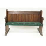 An oak and pine pew with plank back and upholstered seat, 101cm high,