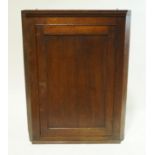A 19th century oak hanging corner cabinet with panelled door, 101cm high, 78cm wide, 40.
