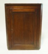 A 19th century oak hanging corner cabinet with panelled door, 101cm high, 78cm wide, 40.