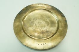 A silver gilt dinner plate, London 1977 and struck out marks, armorial to the centre, 26.