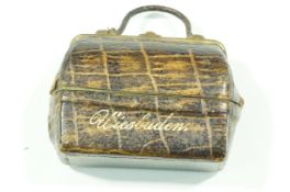 A 19th century travelling inkwell in the form of a Gladstone bag,