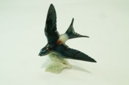 A Goebels figure of a swallow in flight, printed factory marks, paper label, 21.