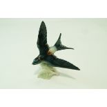 A Goebels figure of a swallow in flight, printed factory marks, paper label, 21.