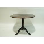 A George III and later mahogany tripod table with round tilt top,