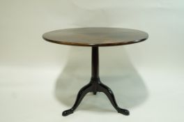 A George III and later mahogany tripod table with round tilt top,
