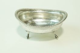 A continental oval bowl, indistinct marks to the base, beaded rim, on four claw leg supports, 12.