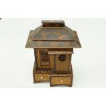 A Japanese parquetry jewellery box in the form of a dwelling with various compartments, 25cm high,