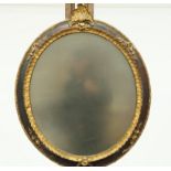 An oval wall mirror in Victorian painted plaster frame, 78cm high,