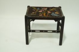 An early 20th century rectangular stool with tapestry seat and pierced stretchers, 41cm high,