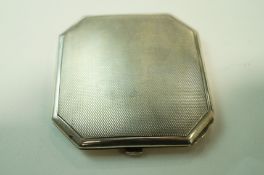 A silver compact, Birmingham 1960, of square cut corner outline with engine turned decoration, 7.
