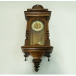 An early 20th century walnut cased regulator clock, the case with turned finials,