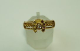 A Victorian diamond and ruby set 18 carat gold horseshoe ring, Birmingham 1890, finger size P,