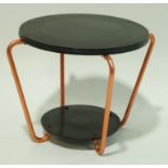 A two tier bakelite table with round disks, linked by four metal supports,