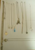 A collection of ten silver or silver coloured pendants on chains