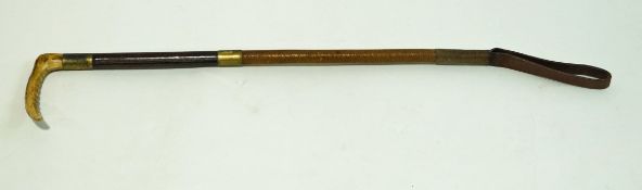 A ladies hunting crop with horn handle and leather brass bound handle,