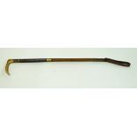 A ladies hunting crop with horn handle and leather brass bound handle,