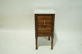An oak narrow chest of three drawers with marble top and turned legs, 75.5cm high, 39cm wide, 43.