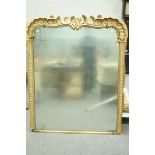 An overmantle mirror with carved and gold painted frame,