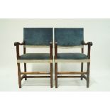 A pair of armchairs with carved mahogany arms,
