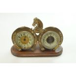 A desk clock and barometer in brass horse shoe frame on mahogany plinth, 20cm wide, 13.