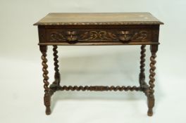 A Victorian oak centre table with carved frieze and one frieze drawer with carved mask handles on