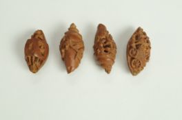 Four late 19th century Chinese carved Canarium Pimete seeds, one fashioned as a button,
