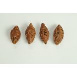 Four late 19th century Chinese carved Canarium Pimete seeds, one fashioned as a button,