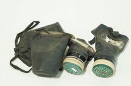 Two WWII gas masks and cases,
